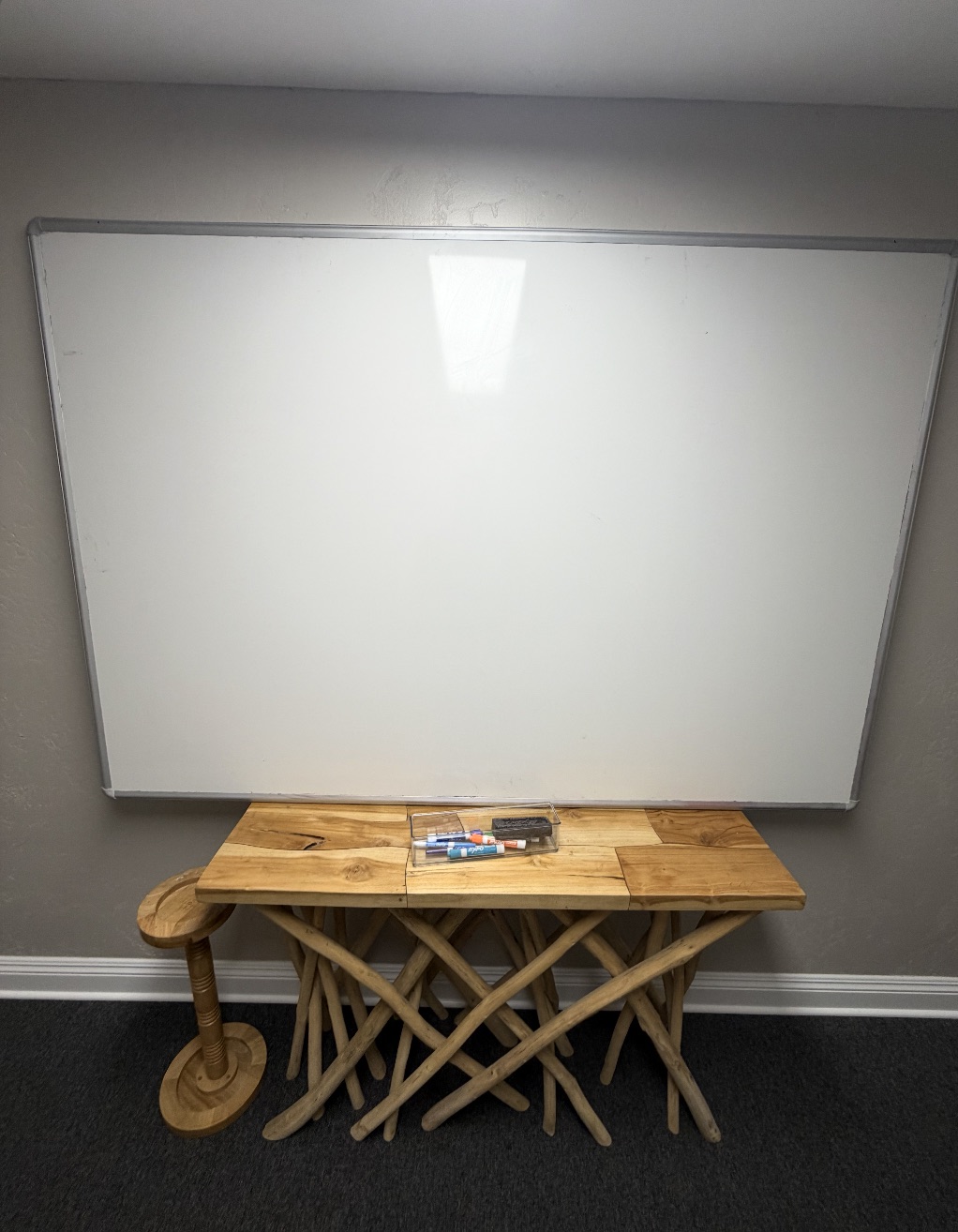 Psychoeducation whiteboard and driftwood table in a Golden Coast Rehab group room